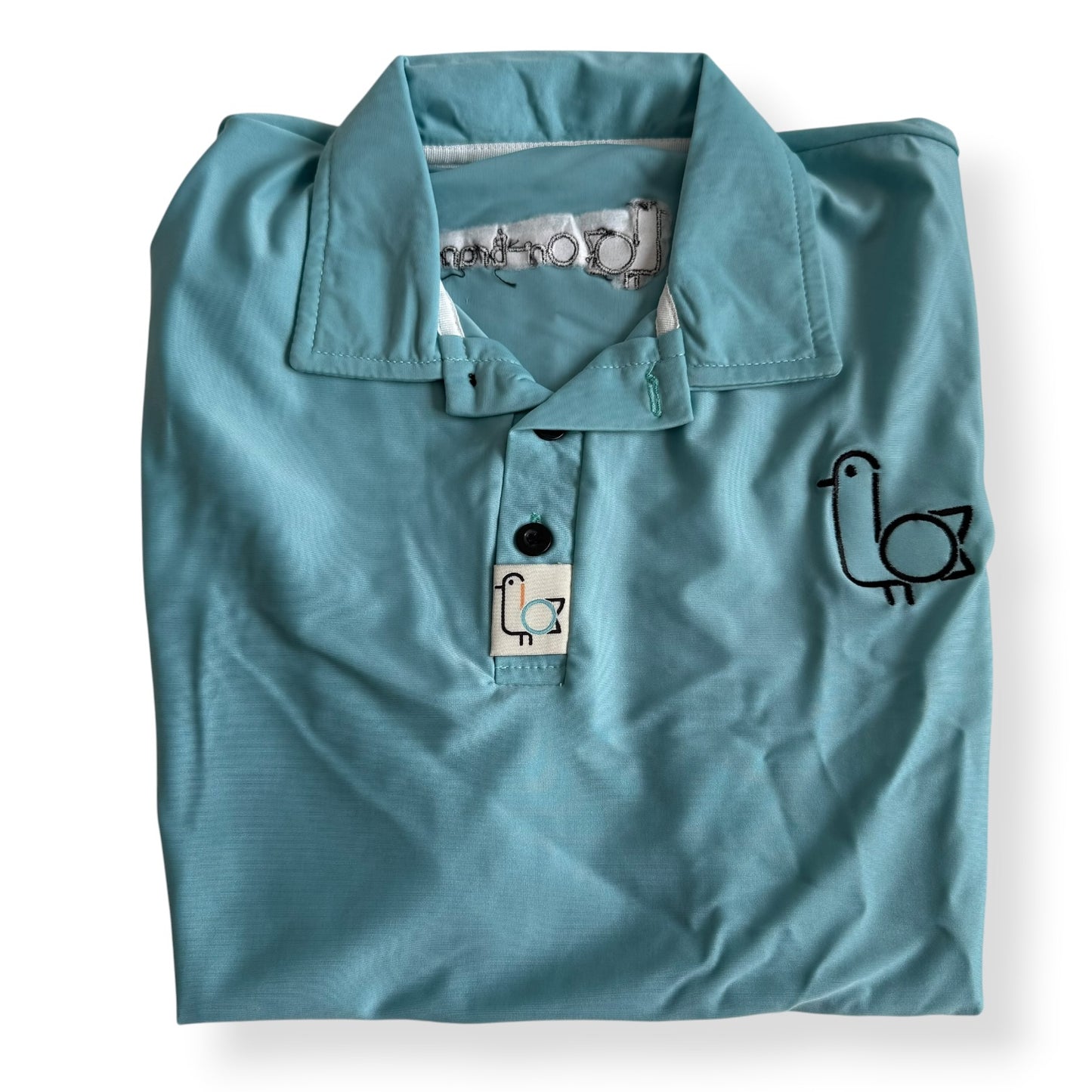 Women's seafoam golf polo with embroidered bird logo, folded flat – On-Brand Golf