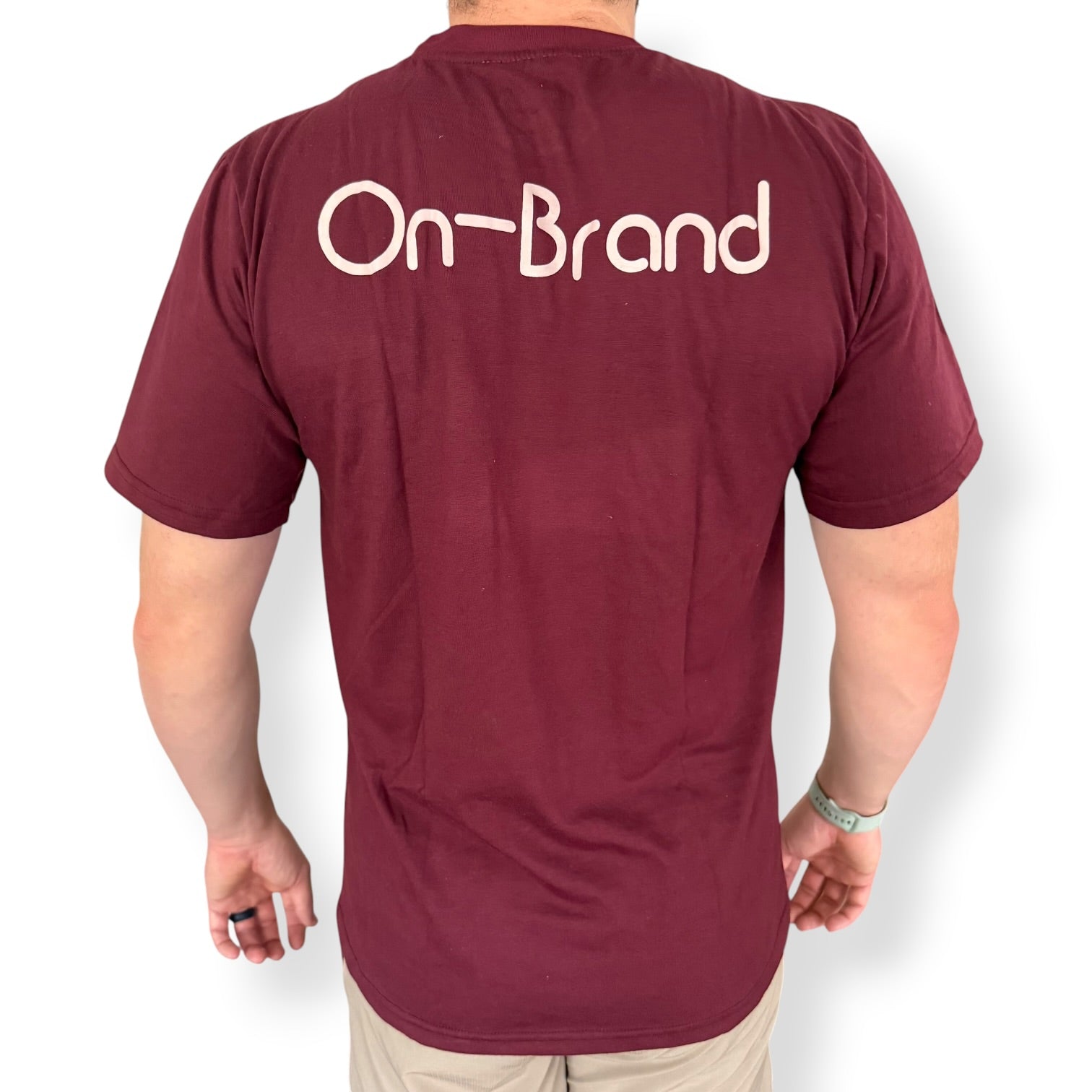 Back of a burgundy On-Brand golf t-shirt on model – On-Brand Golf