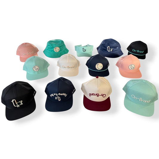 On-Brand Golf Dome Pieces hat collection — navy, burgundy, cream, peach, and seafoam caps with seagull and On-Brand branding