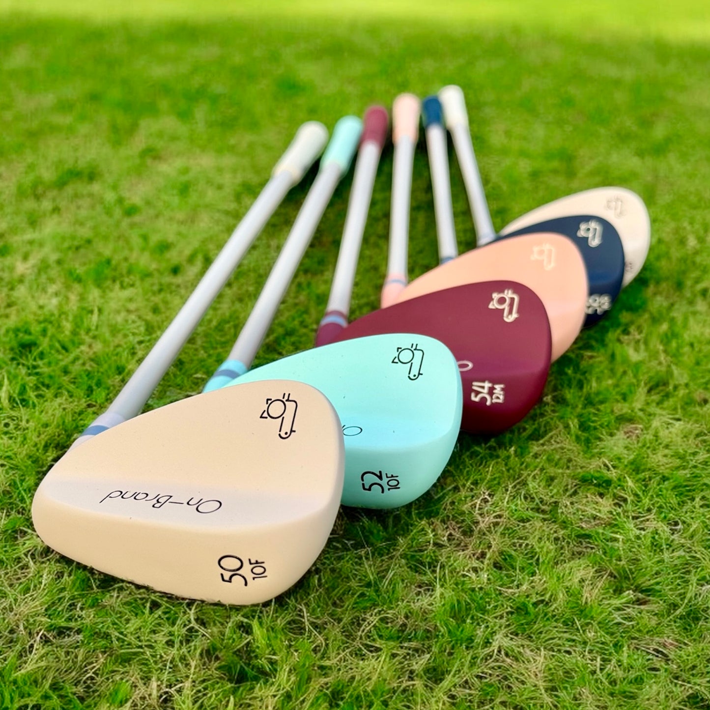 Set of colorful golf clubs on a grassy background