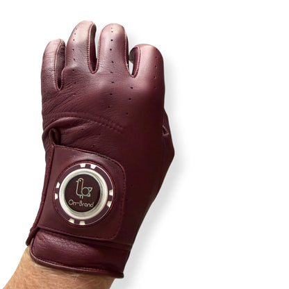 Burgundy golf glove worn on hand with ball marker – On-Brand Golf