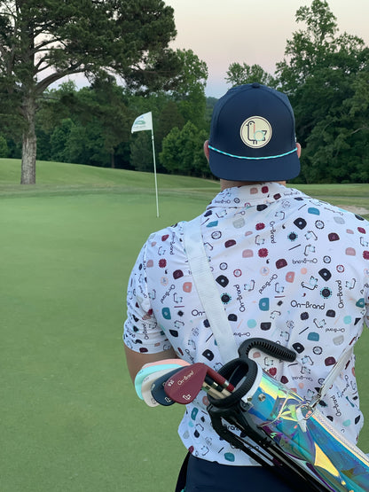 On-Brand print golf polo, back view with clubs on the putting green – On-Brand Golf