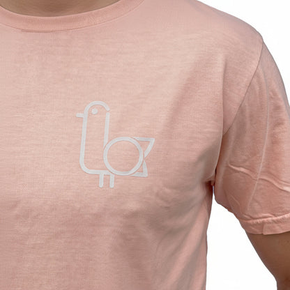 Close-up of the On-Brand Golf seagull logo on a peach t-shirt