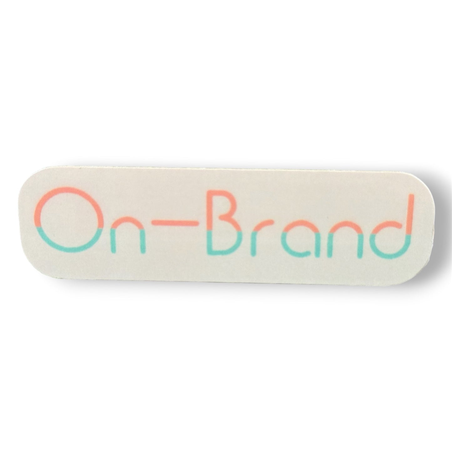 Rectangular cream sticker with 'On-Brand' text in peach and seafoam letters on a white background