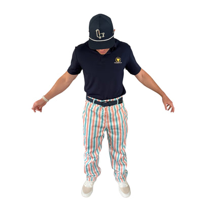 Golfer wearing On-Brand Golf Pair-a-Keets pastel-striped golf trousers with a navy polo and seagull cap, front view