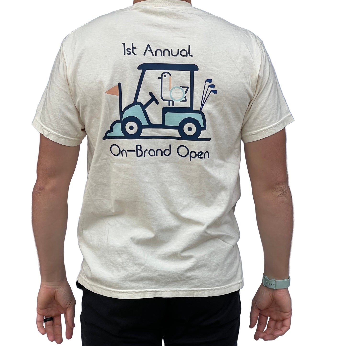 On-Brand Golf cream On-Brand Open t-shirt back on model in studio, 1st Annual golf cart graphic