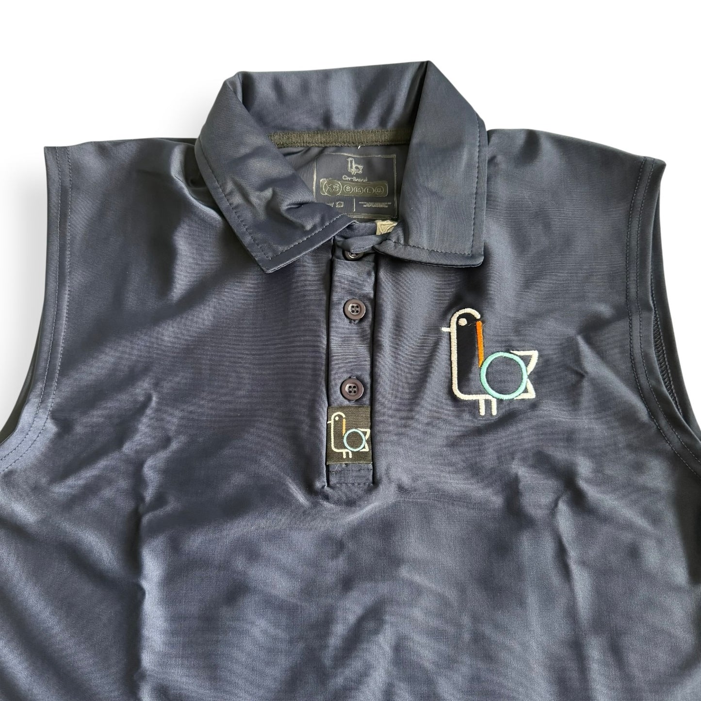 Women's navy sleeveless golf polo with colorful bird crest, front – On-Brand Golf